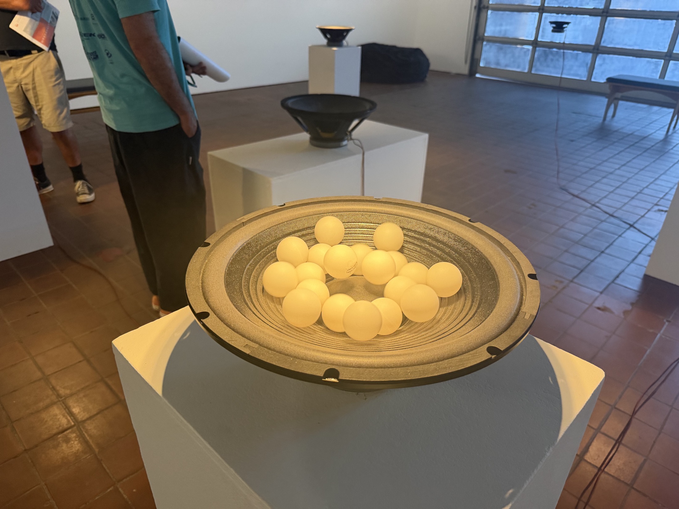 Speakers and hanging lamps in Ess Whiteley's listening materials installation